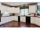 Beautiful kitchen with white cabinets, black appliances, and granite countertops, offering a sleek and modern design at 16307 Stony Ridge Dr, Noblesville, IN 46060