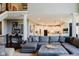 Open-concept living room with staircase, pillars, and modern decor at 16307 Stony Ridge Dr, Noblesville, IN 46060