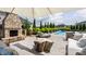 Charming patio with an outdoor fireplace, plush seating, and a refreshing pool with water features at 16310 Nightshore Ln, Fishers, IN 46037