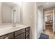 Well-lit bathroom with a clean vanity, chrome fixtures, and a peek into an adjoining room providing comfort at 16310 Nightshore Ln, Fishers, IN 46037