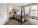 Cozy bedroom with natural light, a metal bed frame, and neutral tones that offers a warm and inviting space at 16310 Nightshore Ln, Fishers, IN 46037