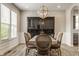 Formal dining room featuring stylish chairs, modern light fixture, and a large cabinet for elegant entertaining at 16310 Nightshore Ln, Fishers, IN 46037