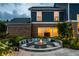 Cozy outdoor fire pit with seating and landscape lighting, perfect for nighttime gatherings at 16310 Nightshore Ln, Fishers, IN 46037