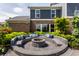 This stylish outdoor space features a custom concrete fire pit and comfortable built-in seating at 16310 Nightshore Ln, Fishers, IN 46037