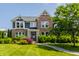 Charming two-story brick home with a well-manicured lawn and lush landscaping at 16310 Nightshore Ln, Fishers, IN 46037