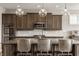 A lovely kitchen boasts stainless steel appliances, stylish lighting, gray backsplash and sleek granite counters at 16310 Nightshore Ln, Fishers, IN 46037