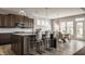 Modern kitchen with a large island, pendant lighting, stainless steel appliances, and an adjacent dining area at 16310 Nightshore Ln, Fishers, IN 46037