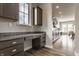 A long kitchen features dark wood cabinets, granite countertops, stainless steel appliances, and a window desk space at 16310 Nightshore Ln, Fishers, IN 46037