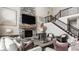 Cozy living room featuring a stone fireplace, mounted television, and comfortable seating area at 16310 Nightshore Ln, Fishers, IN 46037