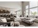 Open-concept living space with high ceilings, large windows, and modern furniture, connected to the kitchen at 16310 Nightshore Ln, Fishers, IN 46037