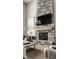 Living room with a stone fireplace, comfortable furniture, and modern design elements at 16310 Nightshore Ln, Fishers, IN 46037