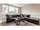 Bright living room with dark gray sectional sofa, large window, and carpeted floor at 16310 Nightshore Ln, Fishers, IN 46037