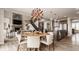 An open-concept living space flows between the kitchen, dining area and living room with fireplace and staircase at 16310 Nightshore Ln, Fishers, IN 46037