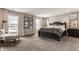 The main bedroom boasts neutral walls, plush carpet, a decorative bed frame, and large sun-filled windows at 16310 Nightshore Ln, Fishers, IN 46037