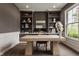 Stylish home office with custom built-in shelving, large windows, and a contemporary desk at 16310 Nightshore Ln, Fishers, IN 46037