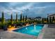 Tranquil pool illuminated at dusk, featuring fountains and surrounded by elegant landscaping at 16310 Nightshore Ln, Fishers, IN 46037