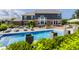 Beautiful swimming pool with water features, surrounded by lush greenery and an inviting fire pit area at 16310 Nightshore Ln, Fishers, IN 46037