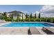 Backyard pool features fountains and nearby lounge chairs; manicured landscaping visible at 16310 Nightshore Ln, Fishers, IN 46037