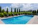 Backyard pool with sleek fountains and manicured landscaping creates a serene oasis at 16310 Nightshore Ln, Fishers, IN 46037