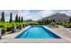 Backyard pool features fountains, lounge chairs and professional landscaping at 16310 Nightshore Ln, Fishers, IN 46037