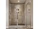 Modern shower with decorative floor and tile and glass doors offering a clean and sophisticated aesthetic at 16310 Nightshore Ln, Fishers, IN 46037