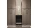 Tall, gray storage cabinets feature long silver handles and decorative backsplash at 16310 Nightshore Ln, Fishers, IN 46037