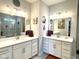 Modern bathroom with double sinks, white cabinets, and decorative accents at 17324 Americana Crossing Xing, Noblesville, IN 46060