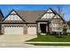Beautiful brick home featuring a three-car garage and manicured lawn at 17324 Americana Crossing Xing, Noblesville, IN 46060