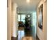 Inviting hallway showcasing hardwood floors leading to a spacious living room at 17324 Americana Crossing Xing, Noblesville, IN 46060