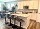 Bright kitchen with white cabinetry, stainless steel appliances, and a stylish island with bar seating at 17324 Americana Crossing Xing, Noblesville, IN 46060