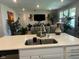 Open-concept kitchen with an island that offers seating and views of the adjacent living room at 17324 Americana Crossing Xing, Noblesville, IN 46060