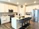 Contemporary kitchen features white cabinets, stainless steel appliances, and a center island with seating at 17324 Americana Crossing Xing, Noblesville, IN 46060