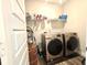 Laundry room with side by side machines and a wire shelf at 17324 Americana Crossing Xing, Noblesville, IN 46060