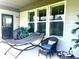 Relaxing covered patio with a hammock, comfortable seating, and stylish decor at 17324 Americana Crossing Xing, Noblesville, IN 46060