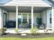 Covered patio featuring an outdoor grill, seating, and well-maintained landscaping at 17324 Americana Crossing Xing, Noblesville, IN 46060