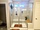 Sleek glass-enclosed shower with built-in seating and modern fixtures for a spa-like experience at 17324 Americana Crossing Xing, Noblesville, IN 46060