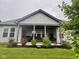 Back patio with a covered space and lush landscaping, perfect for outdoor relaxation at 17324 Americana Xing, Noblesville, IN 46060