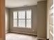 Cozy bedroom showcasing plush carpet and a large window with white shutter blinds at 17324 Americana Xing, Noblesville, IN 46060