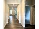 Inviting hallway features wood-look flooring and access to the living area, showcasing the home's open layout at 17324 Americana Xing, Noblesville, IN 46060