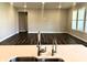 Modern kitchen with bright countertops, stainless steel faucet, and open view to the rest of the living area at 17324 Americana Xing, Noblesville, IN 46060
