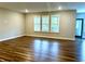 Bright living room features wood floors and multiple windows with lovely views at 17324 Americana Xing, Noblesville, IN 46060