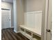 Mud room with built-in bench, storage cubbies, and coat hooks for organization at 17324 Americana Xing, Noblesville, IN 46060