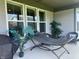 Inviting outdoor porch with a hammock, stylish seating, and potted tropical plants at 17324 Americana Xing, Noblesville, IN 46060