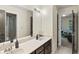 Bathroom with double marble vanity, neutral paint, and a view into the next room at 2034 Dynasty Ridge Rd, Martinsville, IN 46151