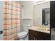 Bathroom with a single vanity and a toilet. The patterned shower curtain adds a splash of color at 2034 Dynasty Ridge Rd, Martinsville, IN 46151