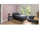 Clean bedroom with wood floors, neutral paint, a black bed, and a window for natural light at 2034 Dynasty Ridge Rd, Martinsville, IN 46151