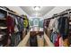 Walk-in closet with custom shelves and drawers for optimal storage and organization, window bringing in natural light at 2034 Dynasty Ridge Rd, Martinsville, IN 46151