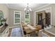 An inviting dining room with a rustic wood table, chandelier, and ample natural light at 2034 Dynasty Ridge Rd, Martinsville, IN 46151