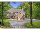 Stately brick home with a circular driveway, surrounded by manicured landscaping and mature trees at 2034 Dynasty Ridge Rd, Martinsville, IN 46151