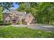 A beautiful two-story brick home with a well-maintained lawn and mature trees at 2034 Dynasty Ridge Rd, Martinsville, IN 46151